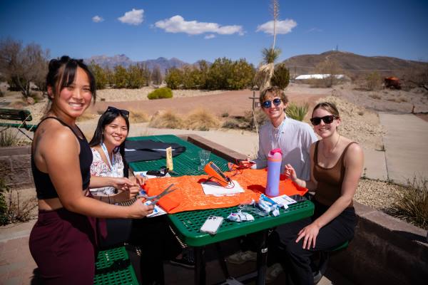 Team assembling their project. Organ Mountains in background